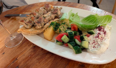 Kipos Greek Taverna signature dishes Chicken Gyro
Moussaka
Souvlakia